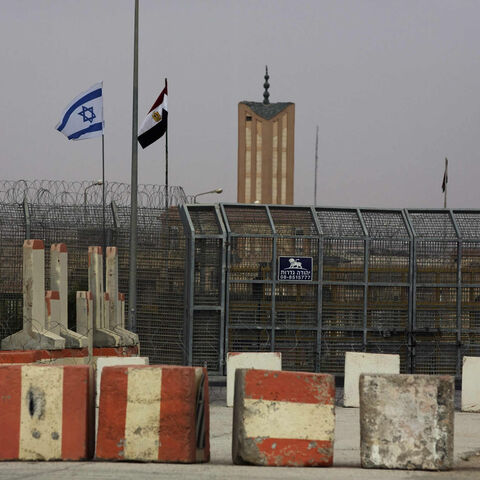 Israeli and Egyptian flags are seen at the Nitzana border crossing along the southern Israeli border with Egypt near the Israeli village of Nitzanei, Sinai Peninsula, Aug. 20, 2013.